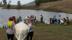 Students carrying row boats